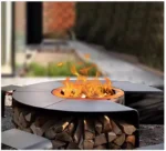 Outdoor fire pit chimnea on patio with flames and grill grate