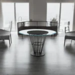 Round glass dining table with black iron pedestal base in a modern dining room setting