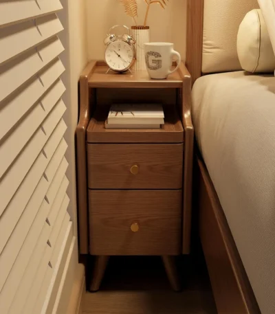 Narrow solid walnut nightstand with two drawers in a modern bedroom setting