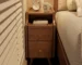 Modern solid walnut nightstand with two drawers in a bedroom setting