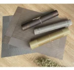 Gold weave placemats on a dining table with plates and cutlery