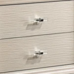 Goldoma traditional 2-drawer nightstand with diamond clear acrylic legs in pearl white finish placed next to a bed