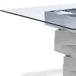 Modern 59-inch square glass dining table with gray solid wood pedestal base, positioned in a dining room