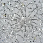 Modern crystal chandelier with chrome K9 crystal tree branches hanging in a dining room