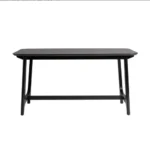 Mid-century modern dining table with black ash veneer top and trestle base in a dining room setting