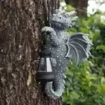 Solar dragon lantern glowing on a tree trunk at night, dragon figurine resin garden decor