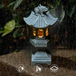Solar pagoda lantern glowing in a garden at dusk, surrounded by flowers