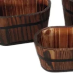 Brown wooden garden planter set with three planters arranged on a patio