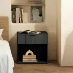 Black nightstand with drawer storage in a modern bedroom setting