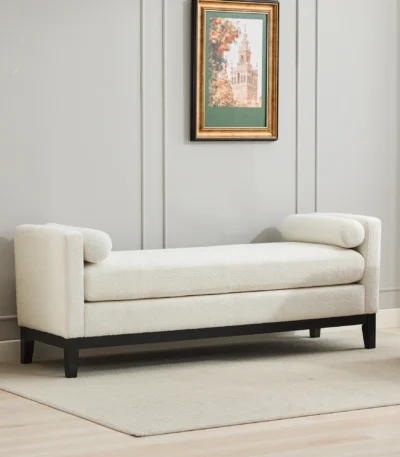 Goldoma upholstered bench daybed ottoman with wood legs and two bolster pillows in a modern living room setting