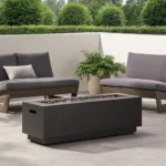 Outdoor propane fire pit in dark grey rectangular iron with glowing flames