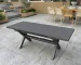 Modern patio dining set with aluminum table and four chairs on a deck