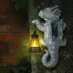 Solar dragon lantern glowing on a tree trunk at night, dragon figurine resin garden decor