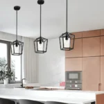 Black cage pendant light hanging from ceiling in a modern restaurant setting with warm ambient lighting.