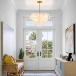 Vintage gold chandelier hanging over a dining table with warm glow