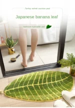 Soft absorbent bath mat in bathroom with banana leaf texture