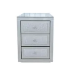 Modern crystal nightstand with drawers featuring mirrored finish and diamond details in a glamorous bedroom setting