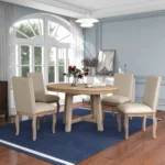 Farmhouse dining table set with extendable round solid wood table and four upholstered chairs in natural wood wash finish