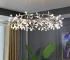 Modern chandelier living room with rose gold branch design hanging above a dining table