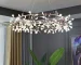Modern chandelier living room with rose gold branch design hanging above a dining table