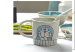 Japanese ceramic dinnerware set with hand-drawn cat design on blue rectangular plate and bowl
