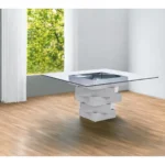 Modern 59-inch square glass dining table with gray solid wood pedestal base, positioned in a dining room