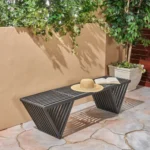 Dark gray solid wood outdoor garden bench with cast iron legs in a garden setting