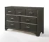 Gray modern bedroom dresser with mirror in a bright bedroom setting