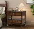 Modern dark cherry nightstand with two drawers and built-in power outlet in a cozy bedroom setting
