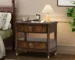 Modern dark cherry nightstand with two drawers and built-in power outlet in a cozy bedroom setting