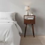Solid wood mini nightstand with one drawer and one open shelf in chestnut brown finish, placed next to a bed in a modern bedroom
