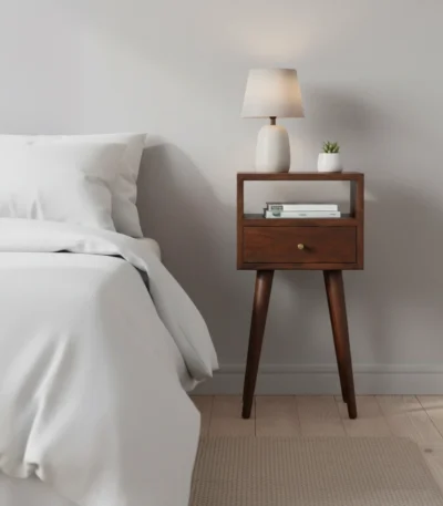 Solid wood mini nightstand with one drawer and one open shelf in chestnut brown finish, placed next to a bed in a modern bedroom
