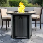 Outdoor gas fire pit column with blue flames on patio