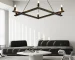 Farmhouse chandelier in black metal with candle-style lights, centered over a wooden dining table in a cozy room.