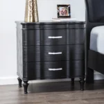 Black solid wood nightstand with curved front and turned legs in a bedroom setting