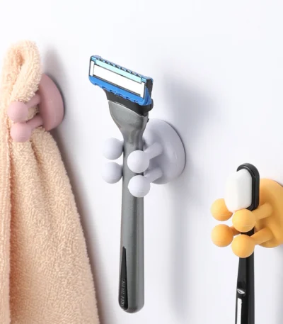 Two-piece set: white silicone toothbrush holder and shaving holder on a bathroom counter.