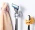 Two-piece set: white silicone toothbrush holder and shaving holder on a bathroom counter.