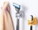 Two-piece set: white silicone toothbrush holder and shaving holder on a bathroom counter.