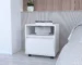 White bedroom side table with drawer and open shelf on wheels in a modern bedroom