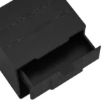 Black nightstand with drawer storage in a modern bedroom setting