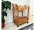 Modern oak wood rolling bar cart with wine storage and metal steel trolley in a living room