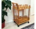 Modern oak wood rolling bar cart with wine storage and metal steel trolley in a living room