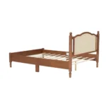 Modern teak finish full size bed with fabric upholstered headboard in a bedroom setting