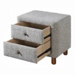 Gray boucle nightstand with two drawers and wooden legs in a modern bedroom setting