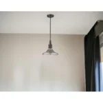 Close-up of the antique bronze finish and textured pebbled glass shade on the hanging light.
