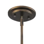 Angle view of the industrial bronze pendant light, with the mesh shade slightly tilted to show the bulb inside.