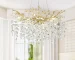 Modern crystal chandelier with tree branch design in a dining room