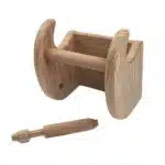 Close-up of the HMS toilet paper holder showing the teak wood grain and stainless steel rod, with a roll of toilet