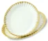 Elegant ceramic dinnerware set with gold rim on a dining table