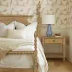 Natural wood nightstand with one drawer and a shelf beside a bed in a bedroom